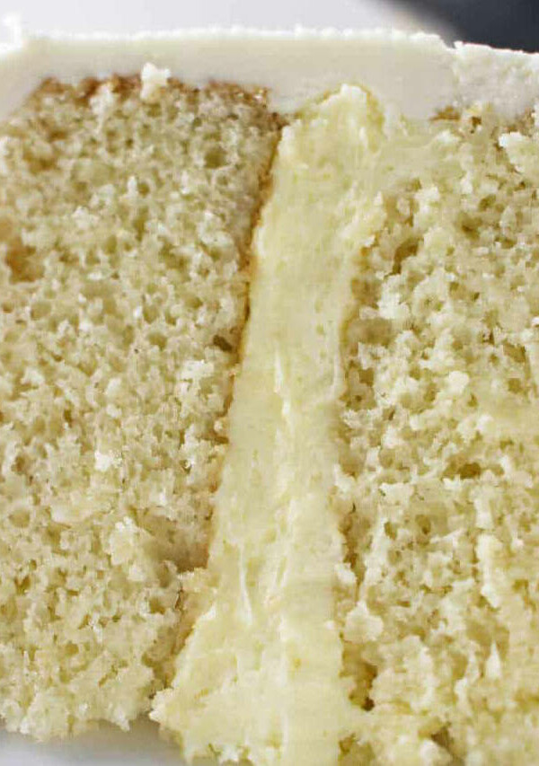 Vanilla cake filling between two layers of cake.