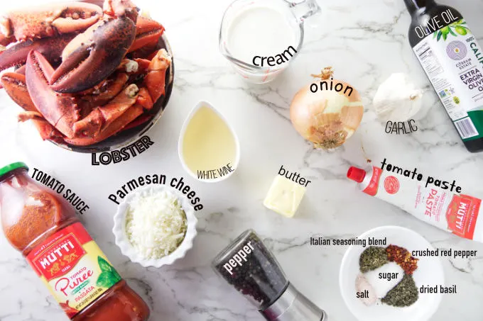 Ingredients needed to make lobster in tomato cream sauce.