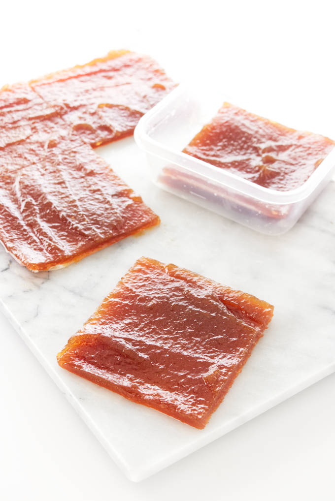 Pear paste sliced into squares and ready to be stored in plastic containers.