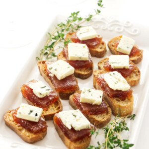 An appetizer plate with pear paste and blue cheese.