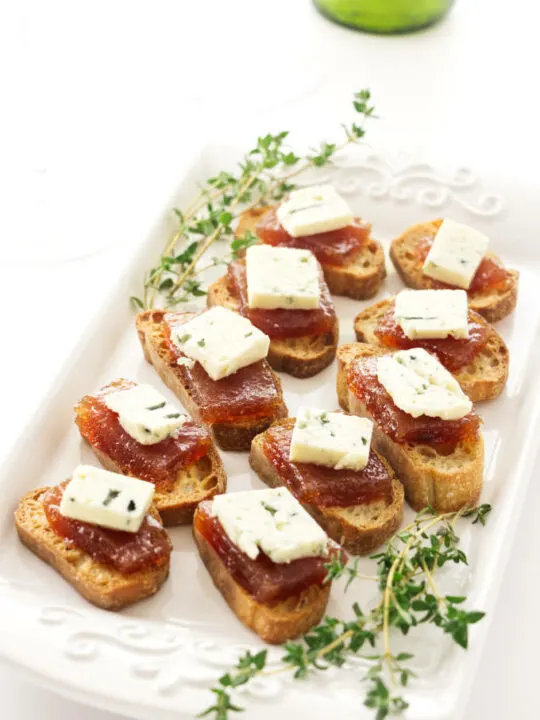 An appetizer plate with pear paste and blue cheese.