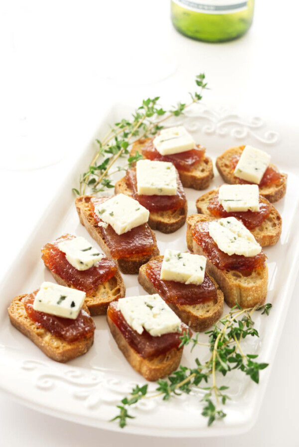 An appetizer plate with pear paste and blue cheese.