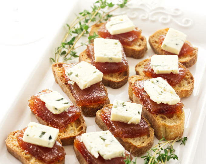 An appetizer plate with pear paste and blue cheese.