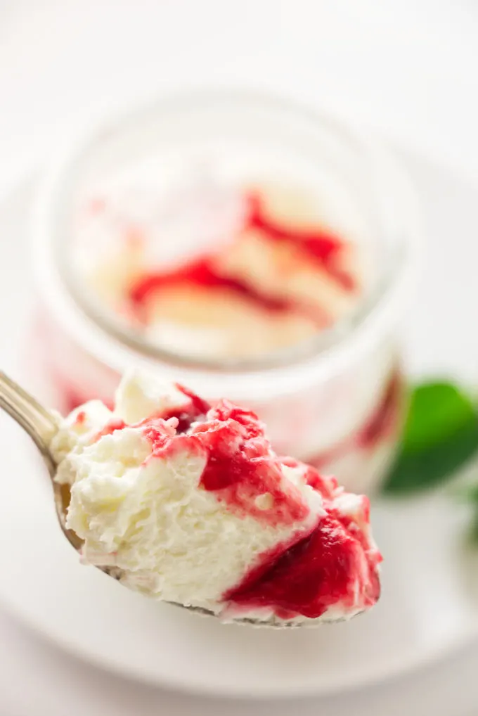 A close up view of a spoonful of raspberry white chocolate mousse