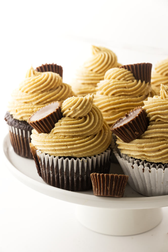 Chocolate cupcakes with peanut butter frosting on platter.