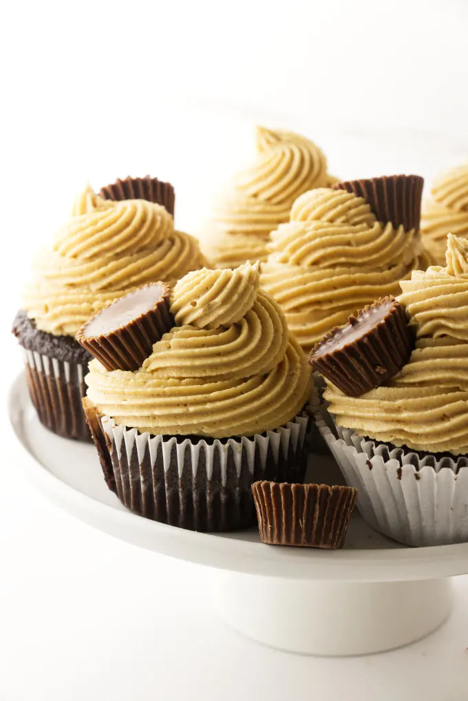 Chocolate cupcakes with peanut butter frosting on platter.