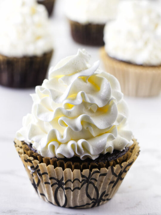 Italian meringue buttercream piped on a cupcake.