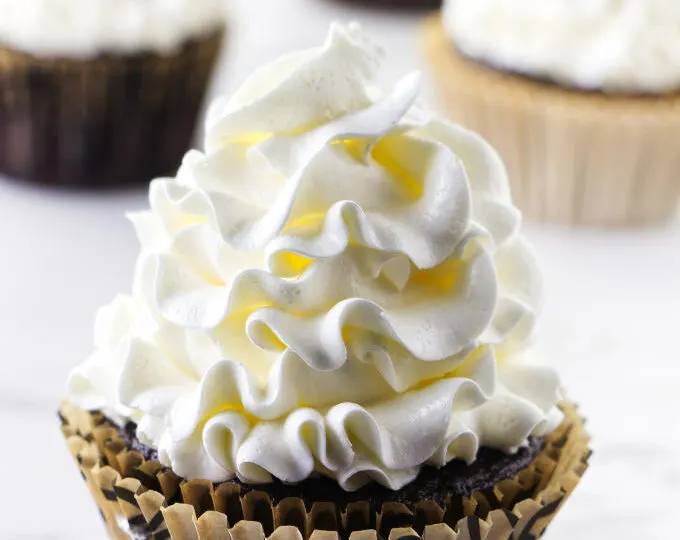 Italian meringue buttercream piped on a cupcake.