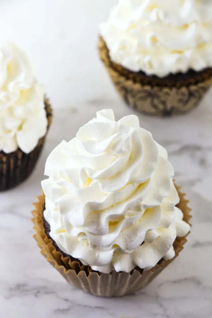 Italian meringue buttercream on three cupcakes.
