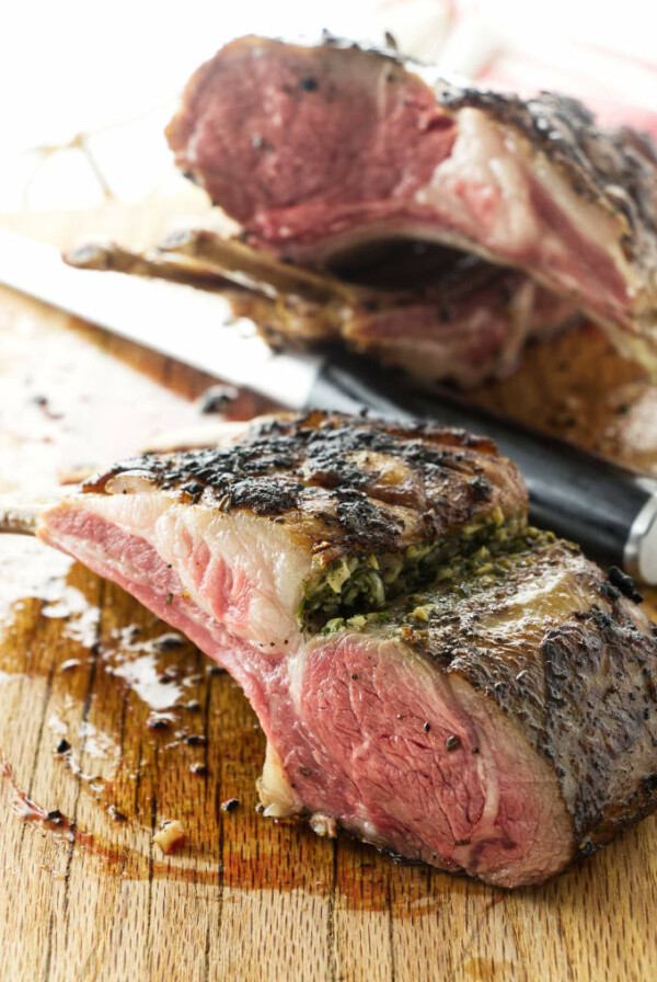 Sous Vide Garlic-Rosemary Rack of Lamb on carving board partially cut into chops