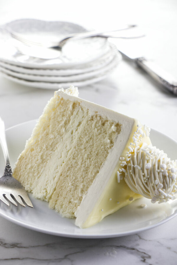 Close up of a slice of white chocolate cake.