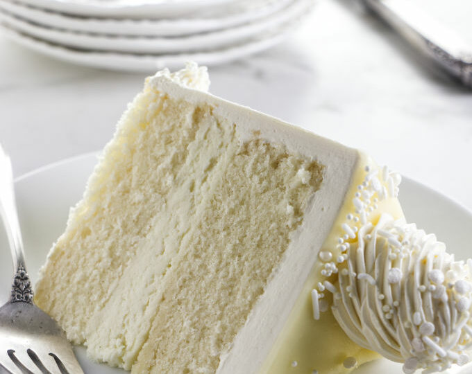 Close up of a slice of white chocolate cake.