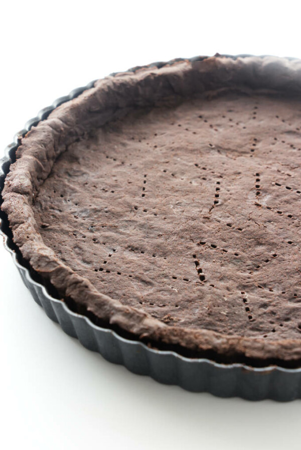 A chocolate shortbread crust in a tart pan.