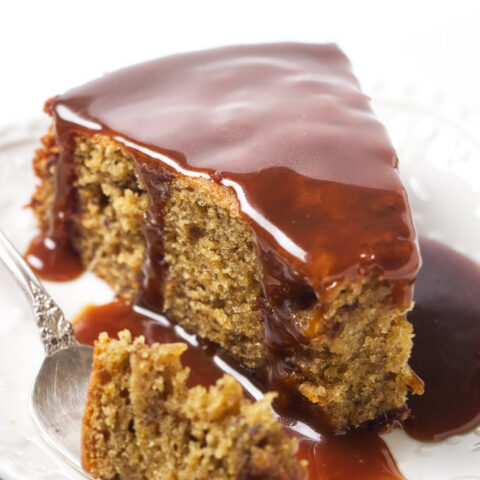 A slice of date cake with toffee sauce.