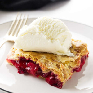 A serving of strawberry-rhubarb slab pie with a scoop of ice cream