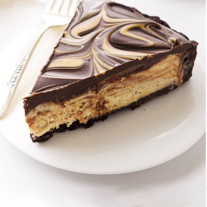 A slice of chocolate peanut butter tart on a plate.