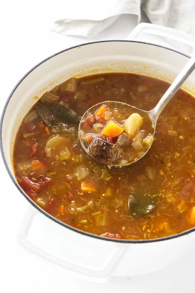 Large pot of soup with a ladle