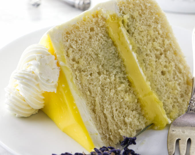 A slice of lemon lavender cake with lemon curd in the center.