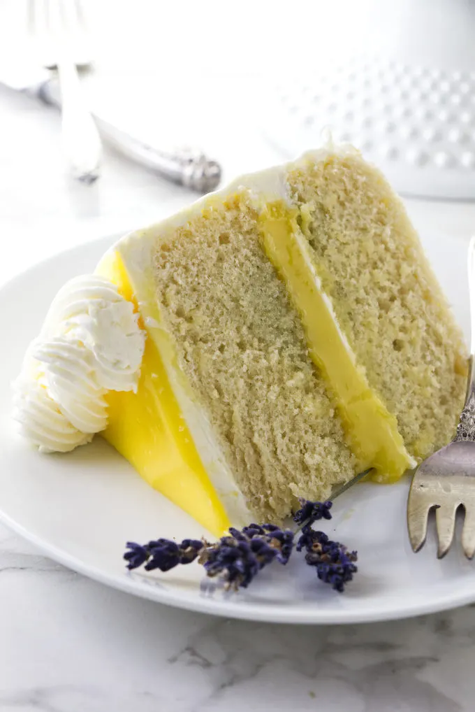 A slice of lemon lavender cake with lemon curd in the center.