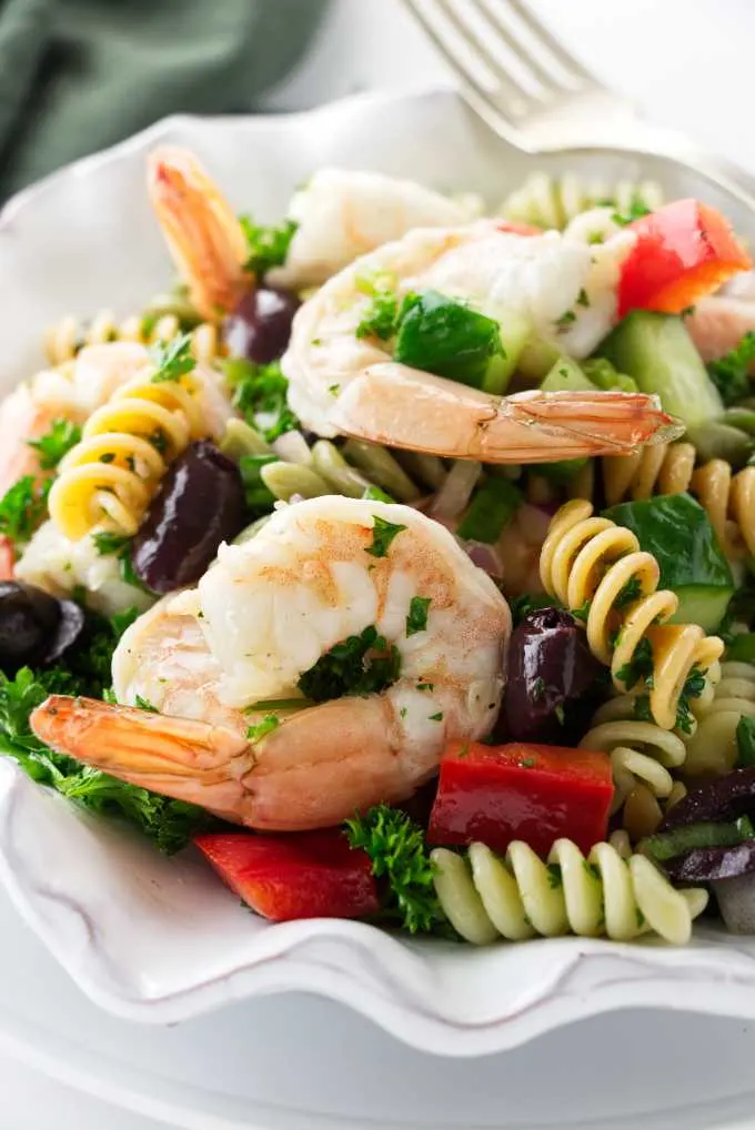 Close up view of a serving of pasta salad with shrimp