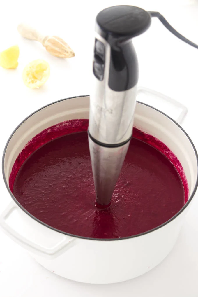 Roasted beet soup being pureed with stick blender