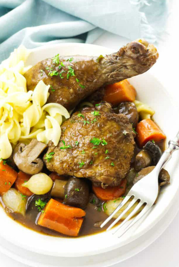 Chicken and vegetables on a plate with noodles.