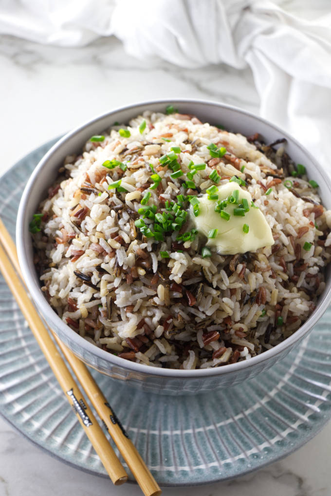 A bowl of royal blend rice with a pat of butter on top.