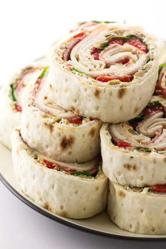 A plate with Italian pinwheel sandwiches.