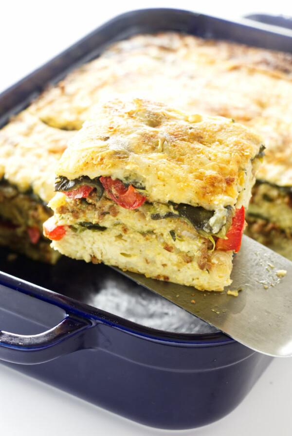 Serving of Poblano Chorizo Strata being lifted from dish