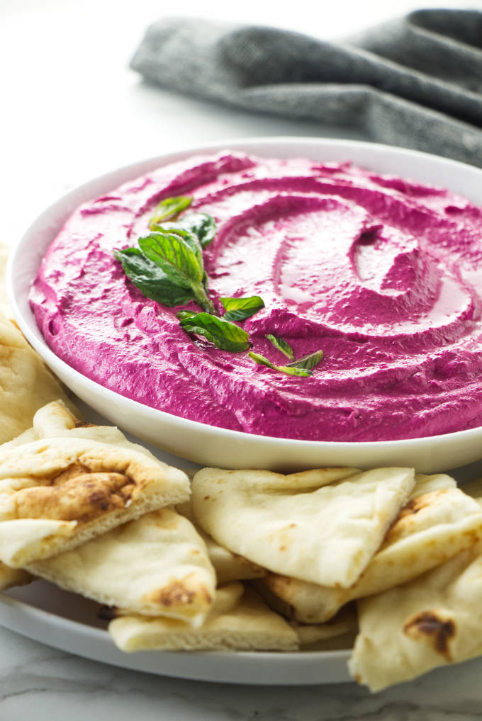 Red beet labneh in a serving dish.