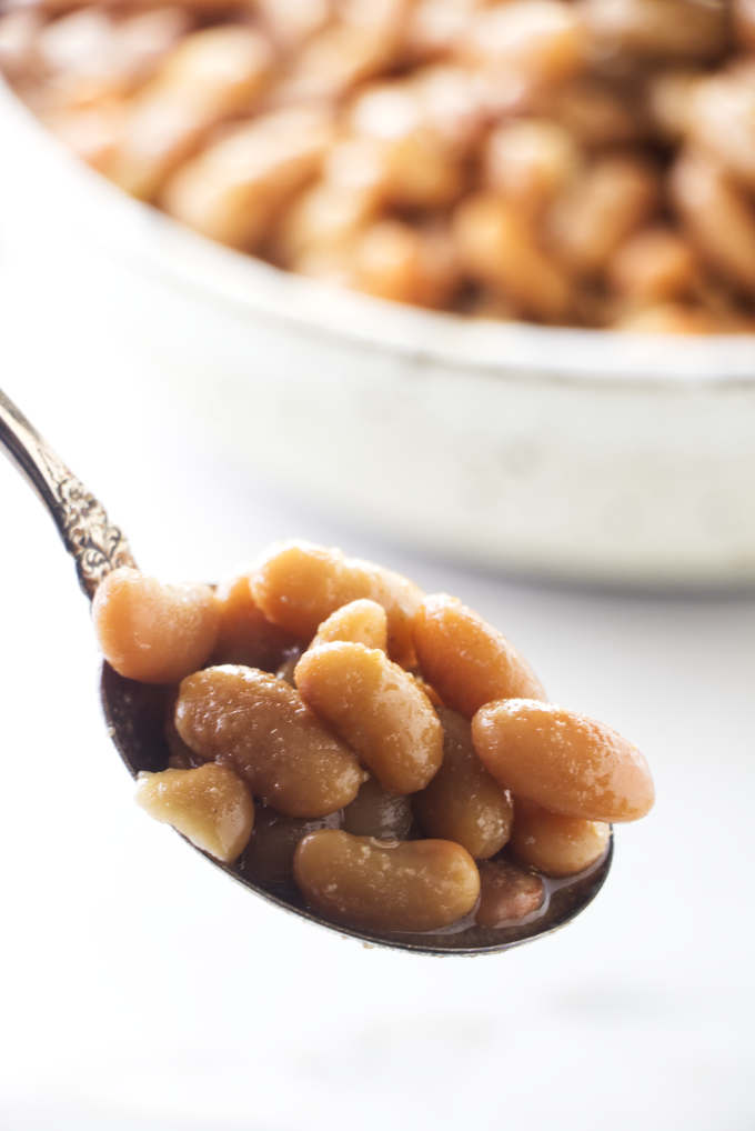 Cooked mayocoba beans on a spoon.