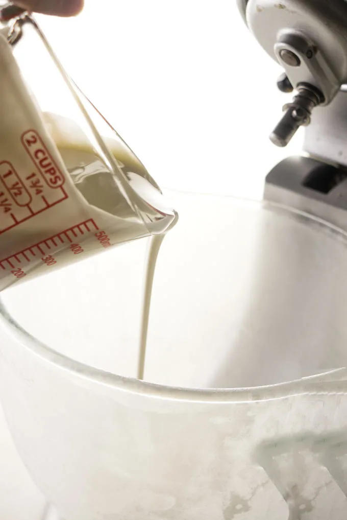 Pouring heavy cream into a chilled bowl.