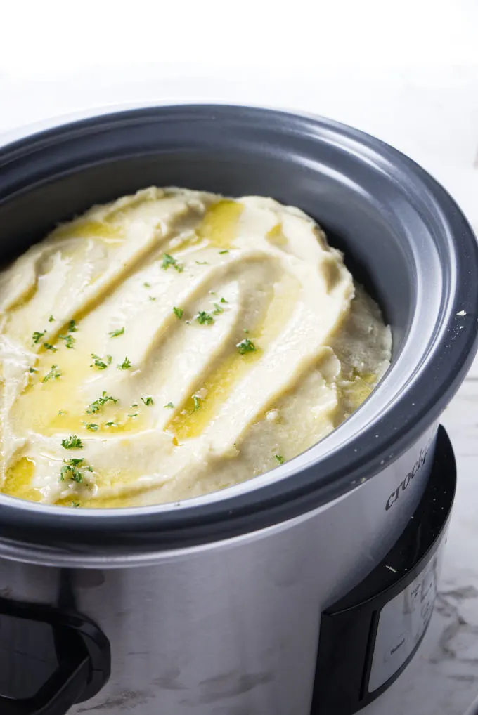 A large batch of mashed potatoes in a slow cooker.