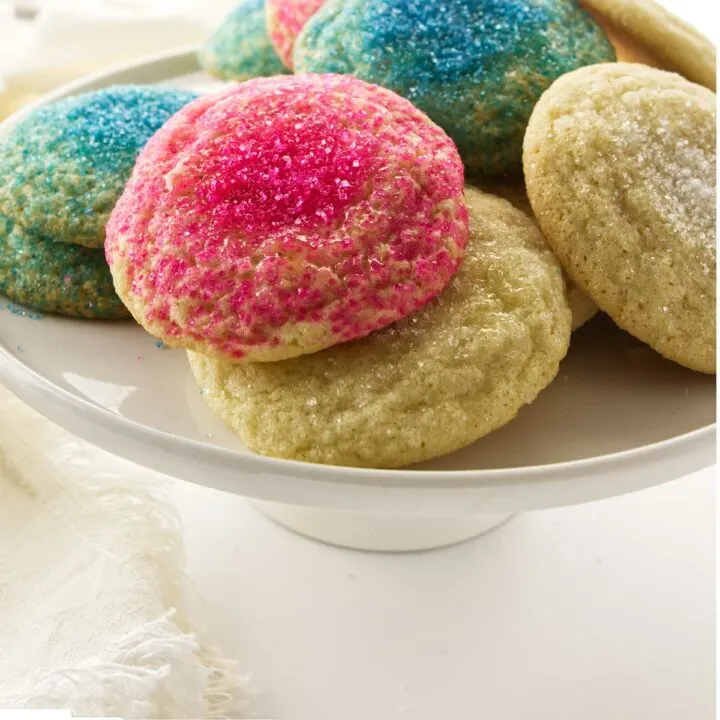 Soft sugar cookies with pink, blue, and white sugar on top.