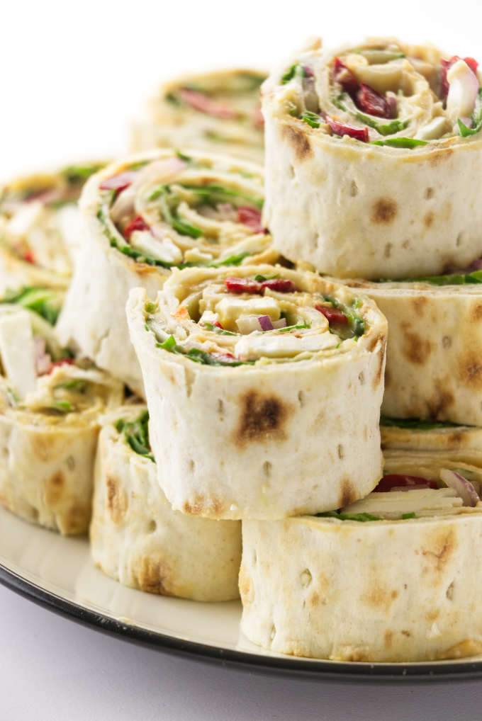 A stack of vegetarian hummus pinwheels.