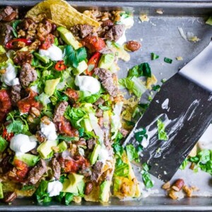 A baking sheet filled with nachos.