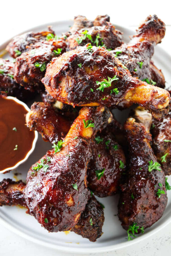 Barbecue baked chicken legs on a platter.