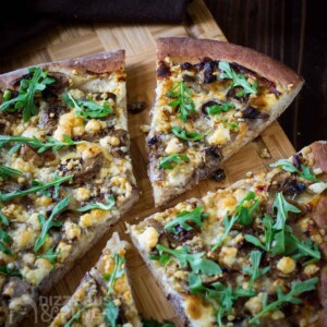 A sliced pizza topped with leftover steak.