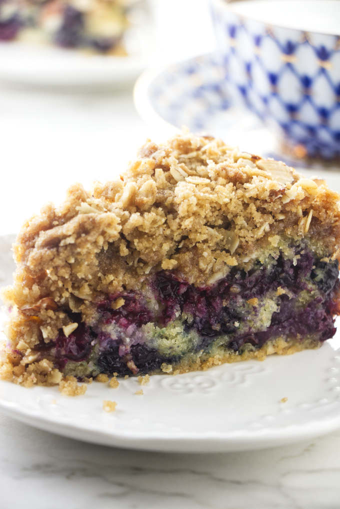 A slice of blueberry buckle cake on a dessert plate.
