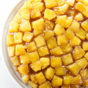 An overhead view of a pineapple upside down cake with pineapple chunks on top.