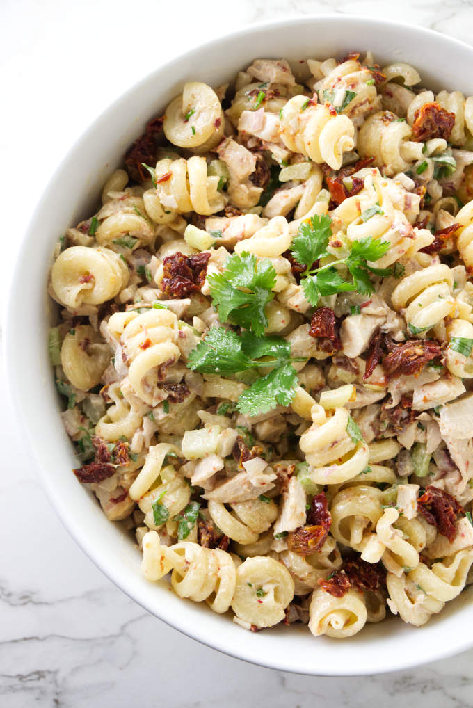 A large salad bowl filled with chicken pasta salad with chipotle dressing.