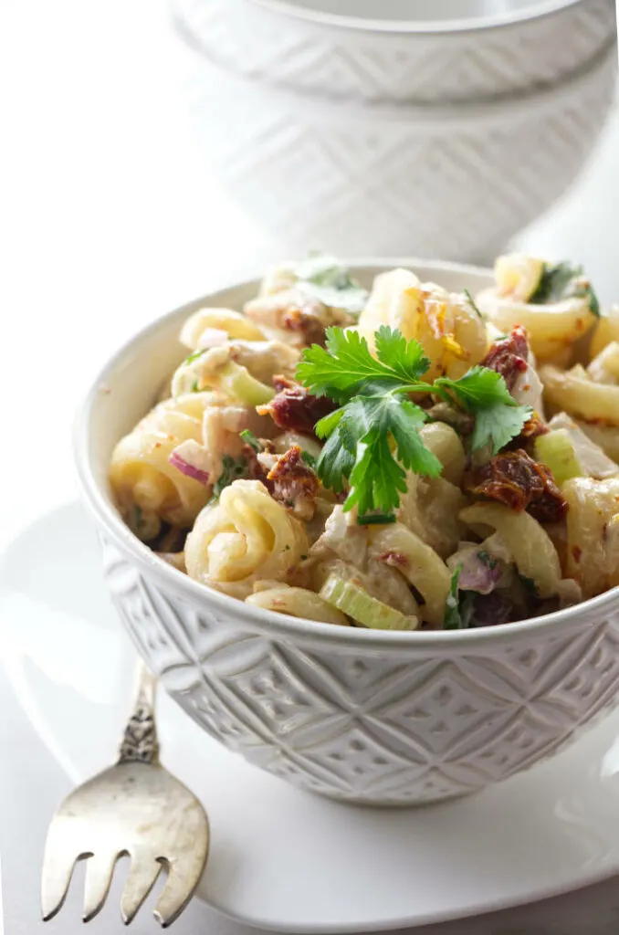 A dish of pasta salad with chicken and chipotle dressing.