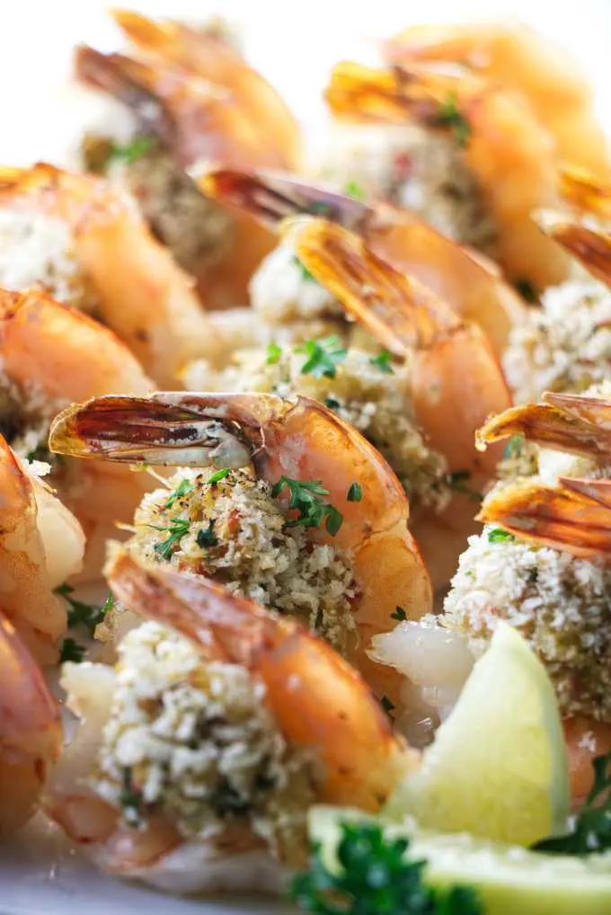 A plate of crab stuffed shrimp placed in rows.