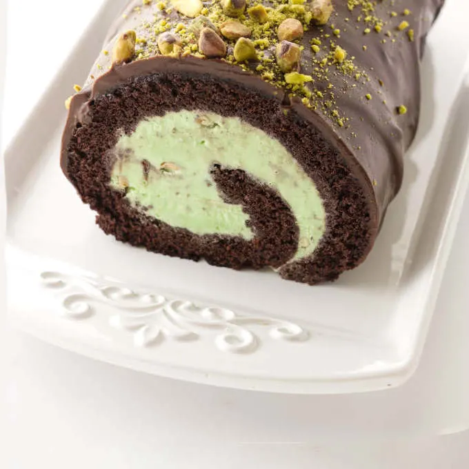 Close up view of chocolate and pistachio ice cream cake roll