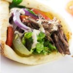 A beef shawarma sandwich in pita bread.