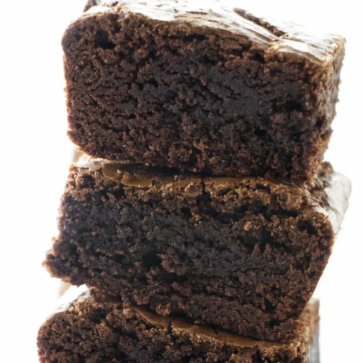 A stack of three fudgy brownies made with three kinds of chocolate.