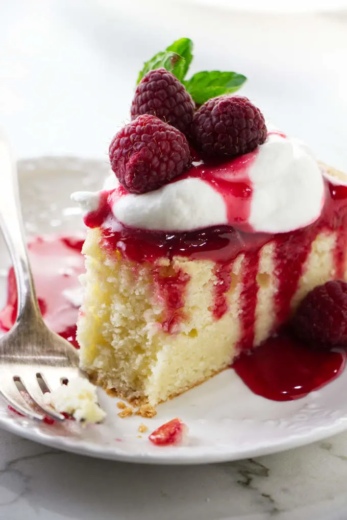 A fork next to a slice of lemon ricotta cake.