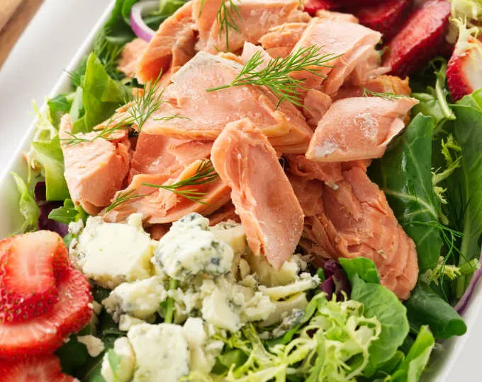 Overhead view of a bowl of Salmon Salad with Strawberries