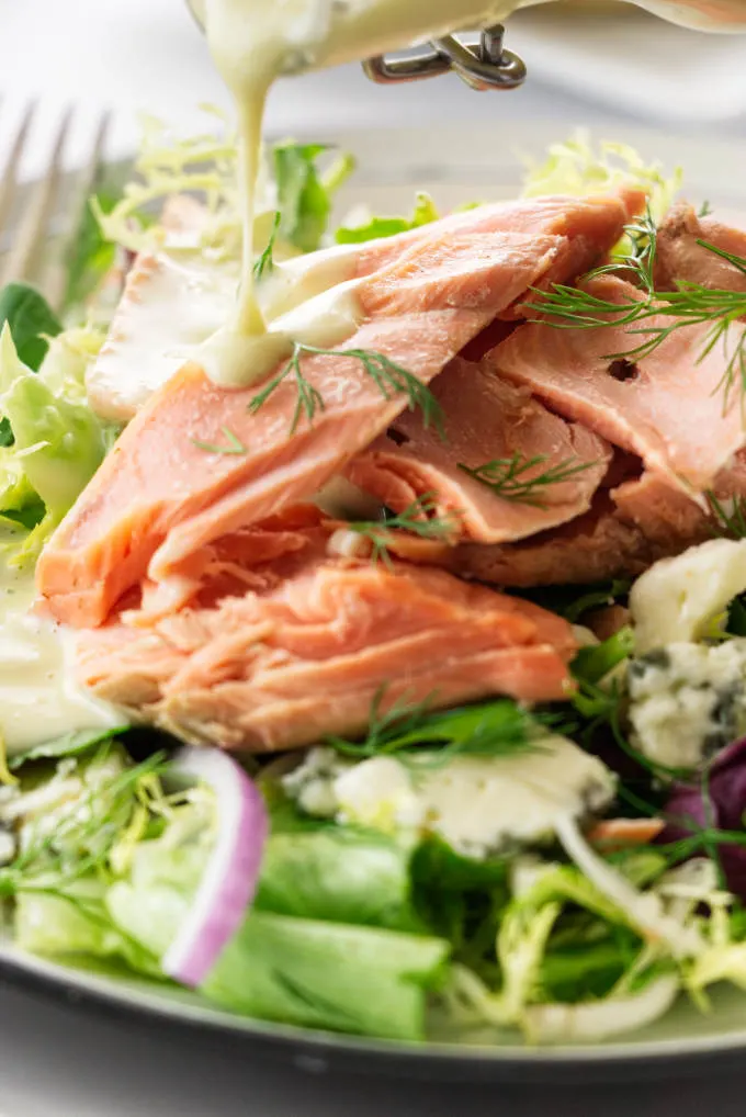 Close up view of a serving of Salmon Salad and vinaigrette