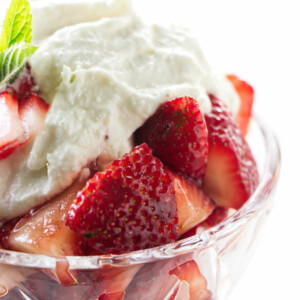 A dish of marsala strawberries with sweetened ricotta on top.